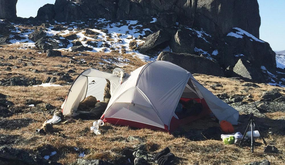 two tents on a hillside