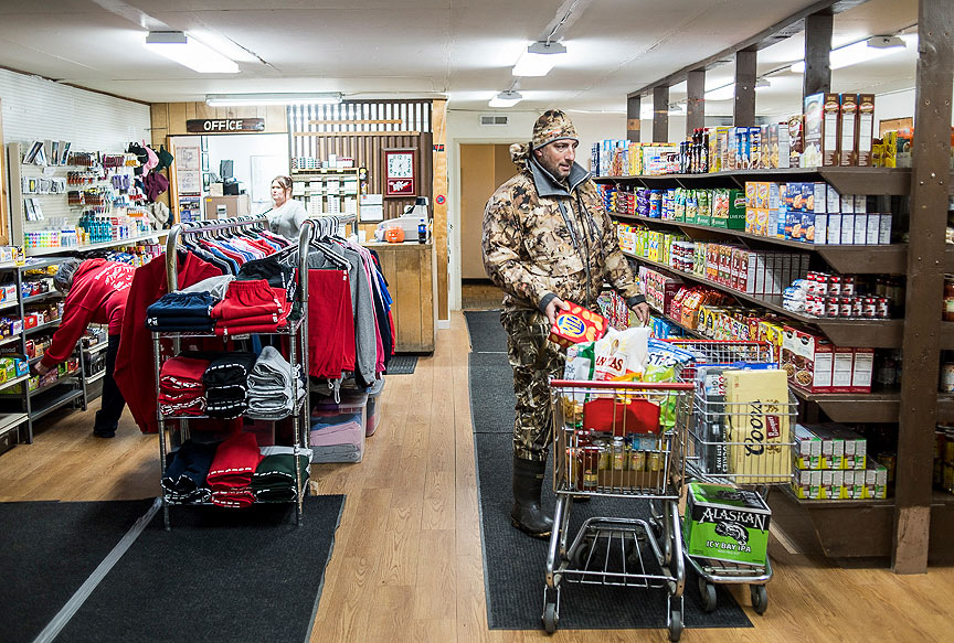 Hunter in full camo shopping for supplies