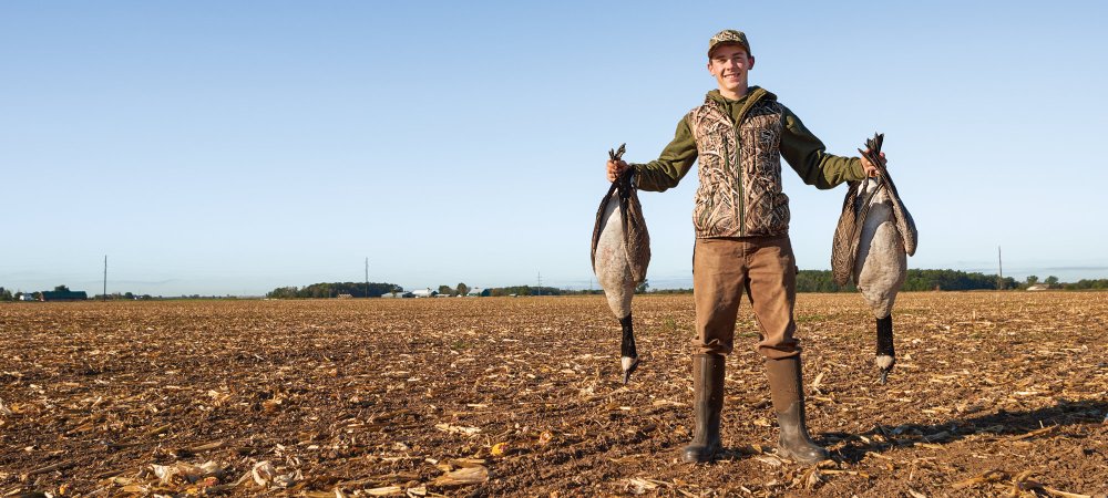 young geese hunter in field