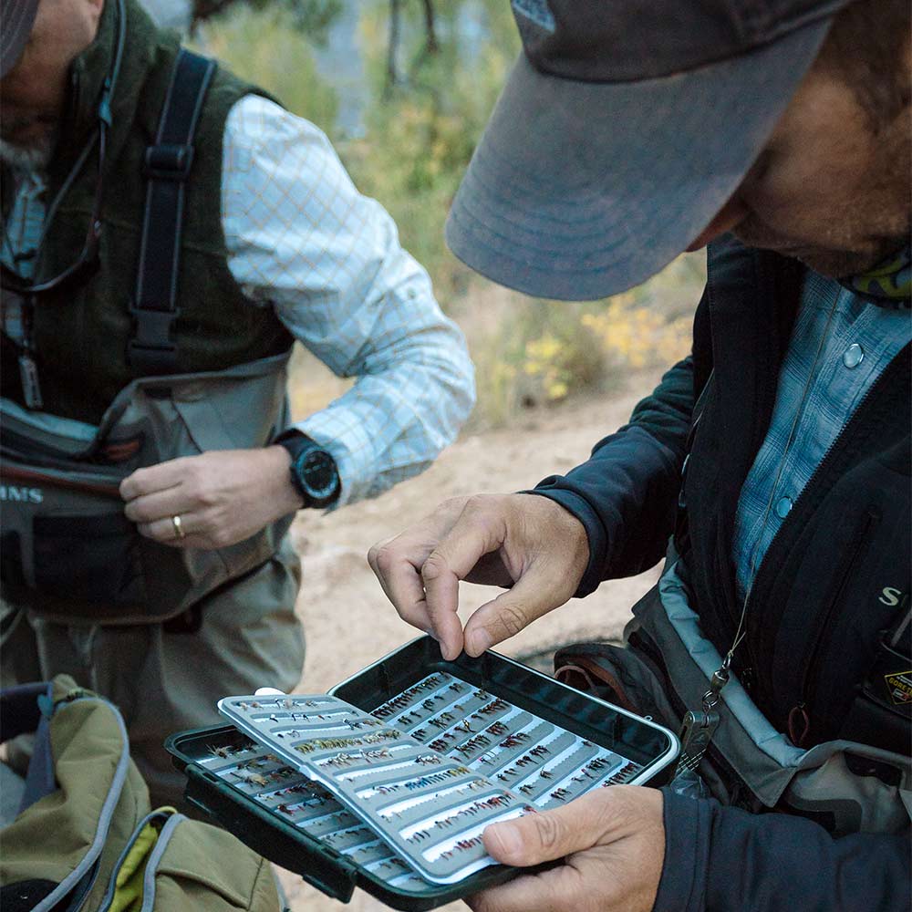 fisherman and fly fishing box