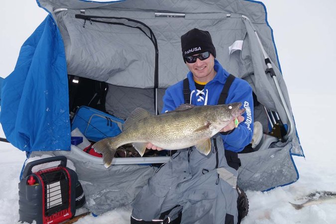 fisherman holding up a walleye