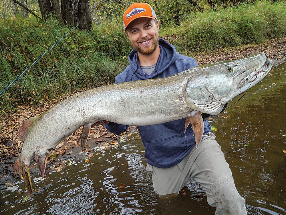 luke swanson holding a giant muskie