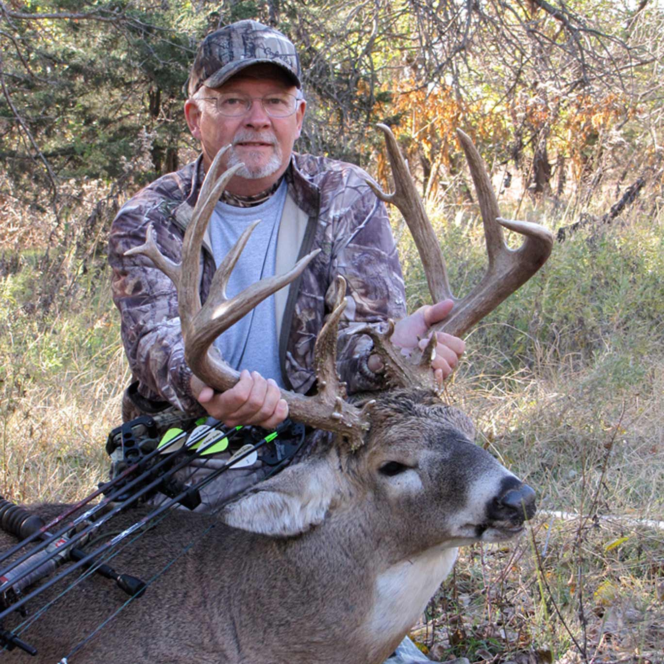 hunter holding up deer antlers