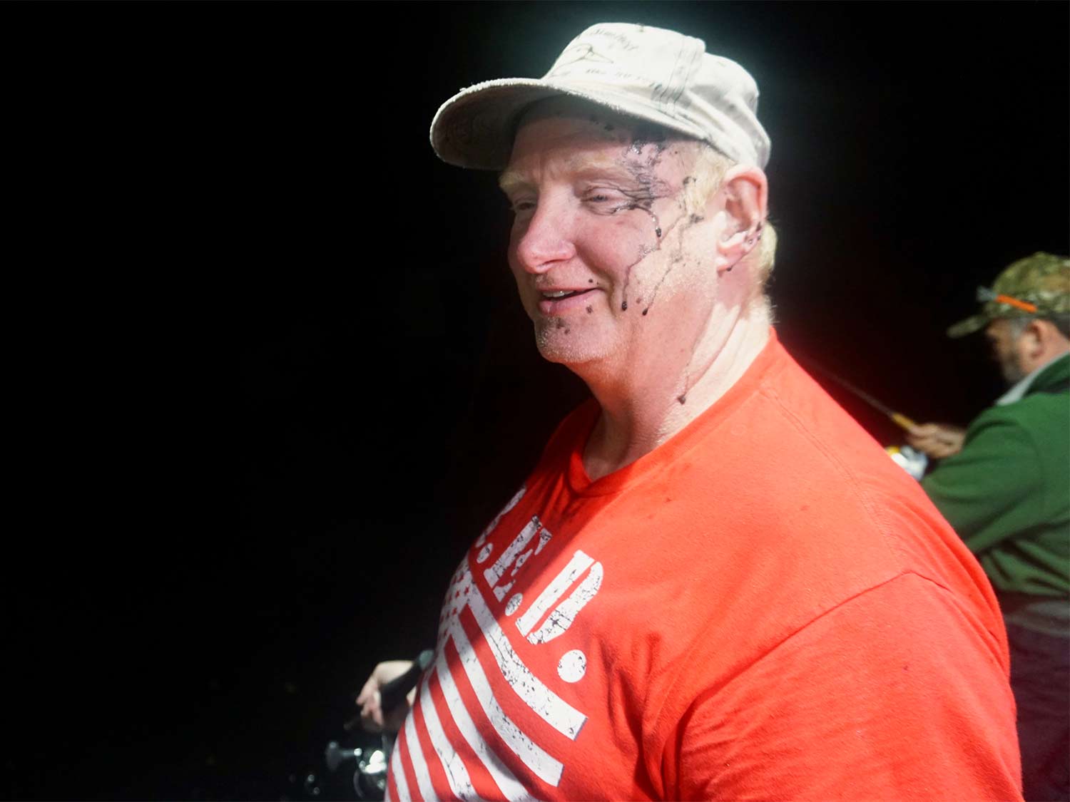 a man in a red shirt with squid ink on his face