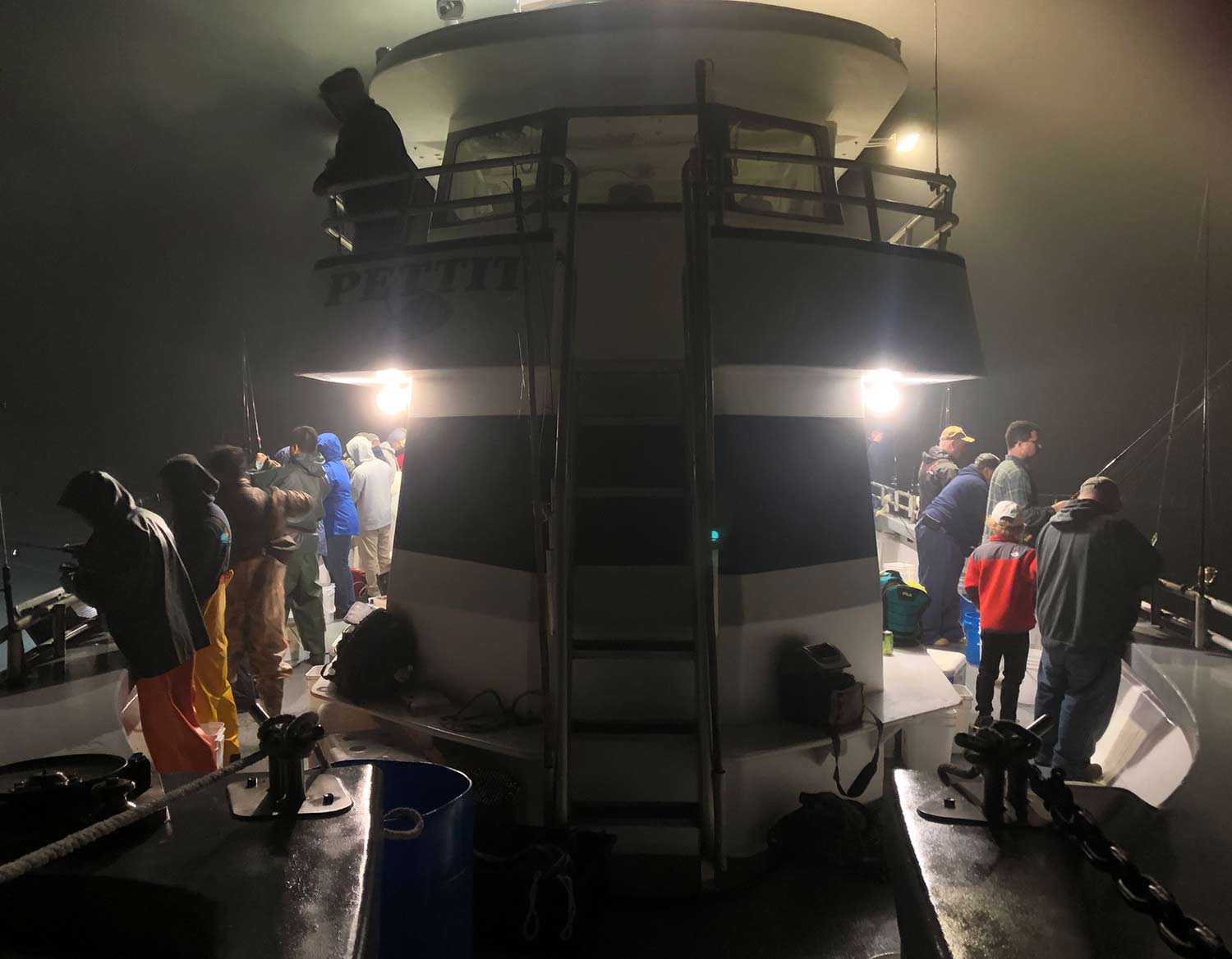 several fisherman fishing at night