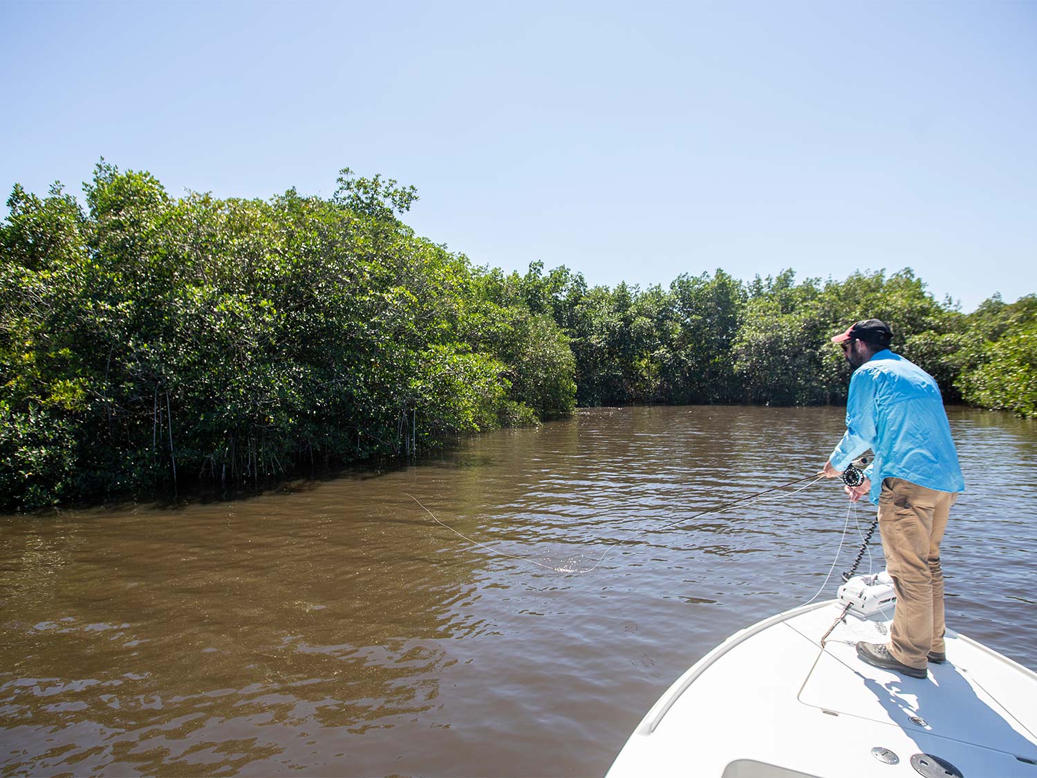 man fishing off the front of a boat on St. Lucie