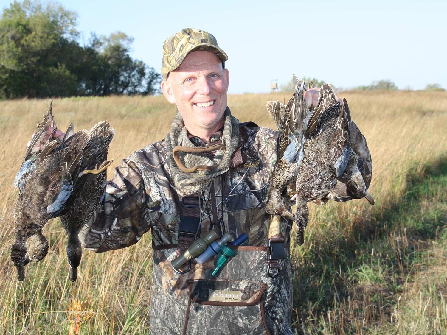 hunter holding up ducks