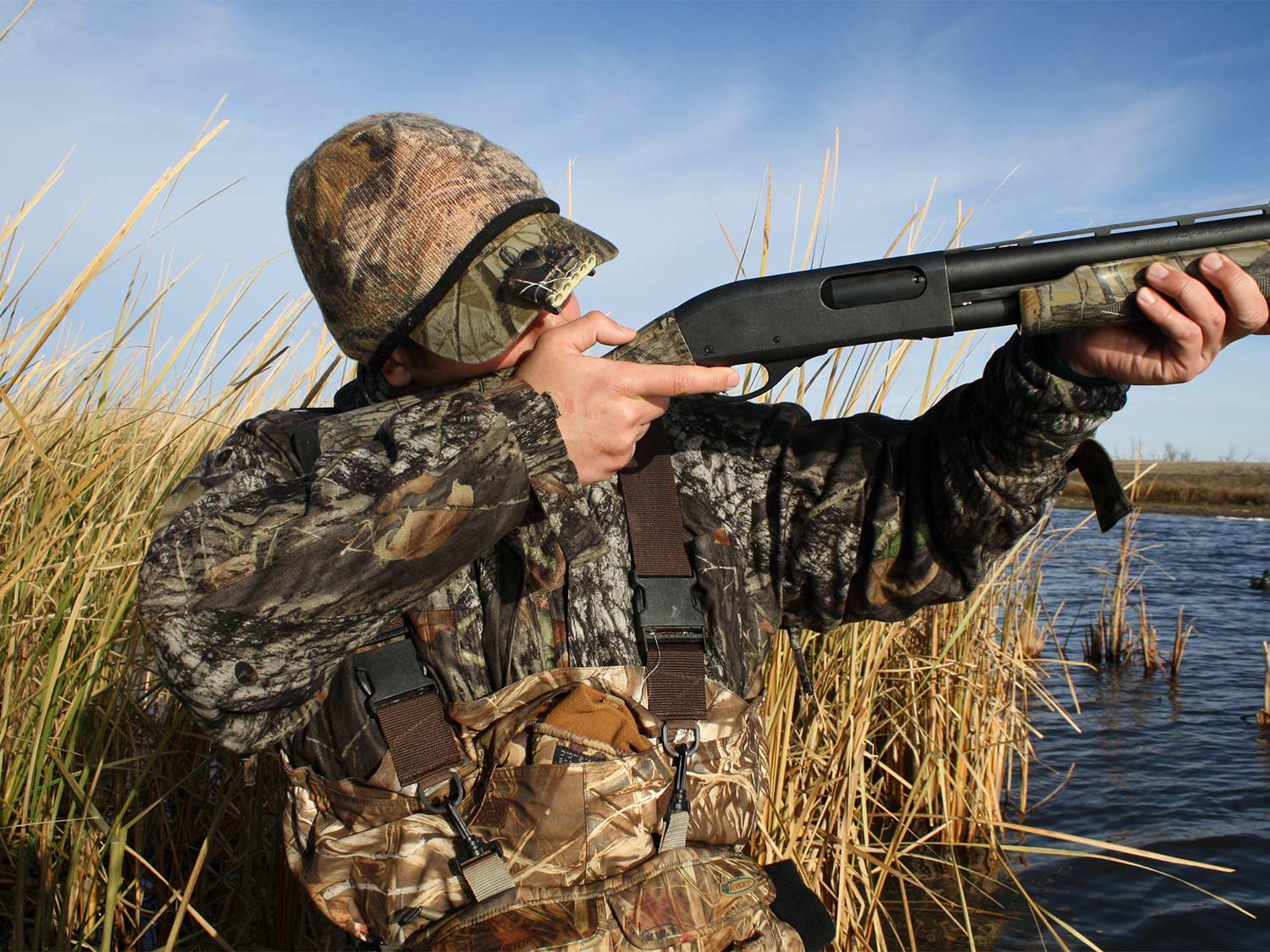 hunter aiming a shotgun