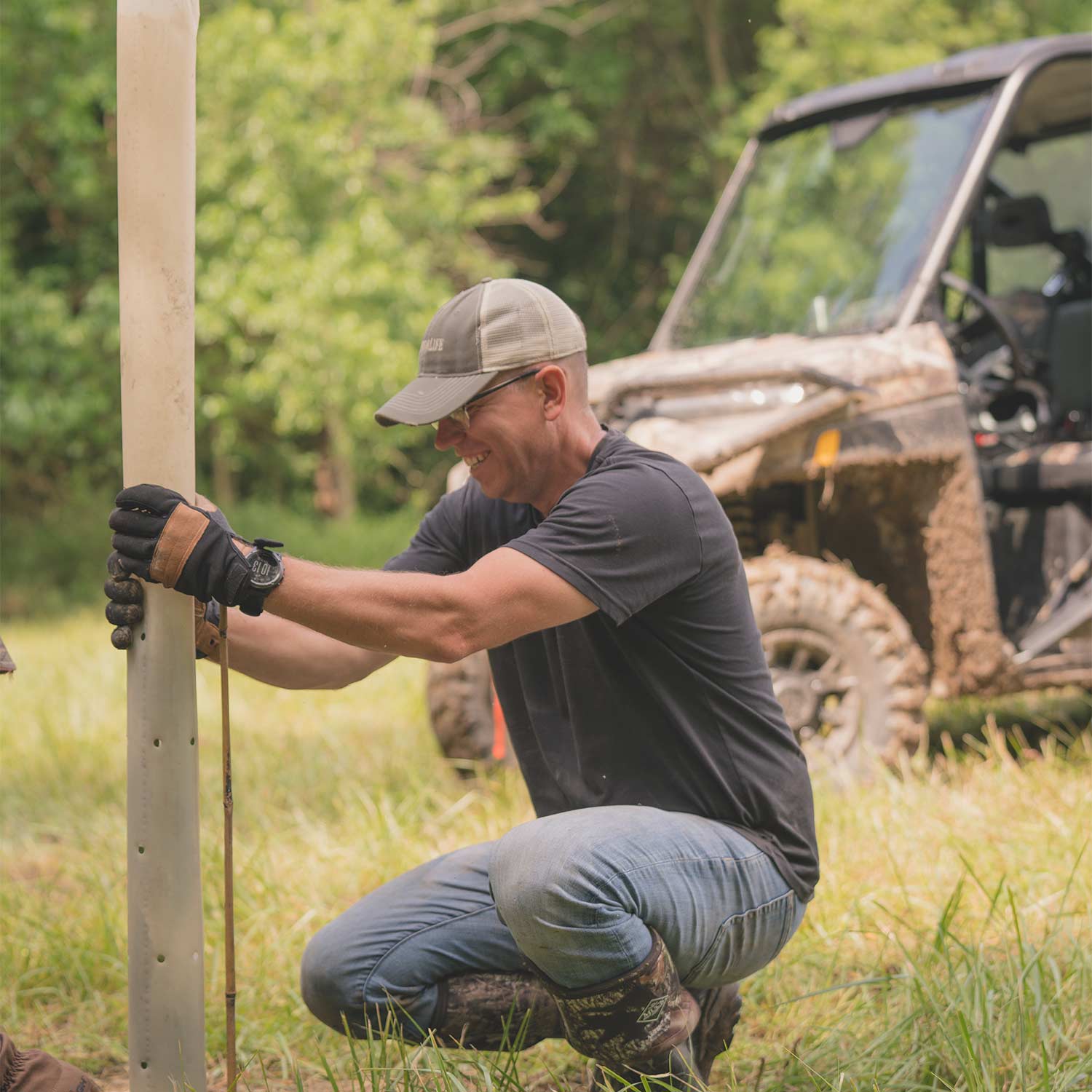 hunter installing tube around a tree