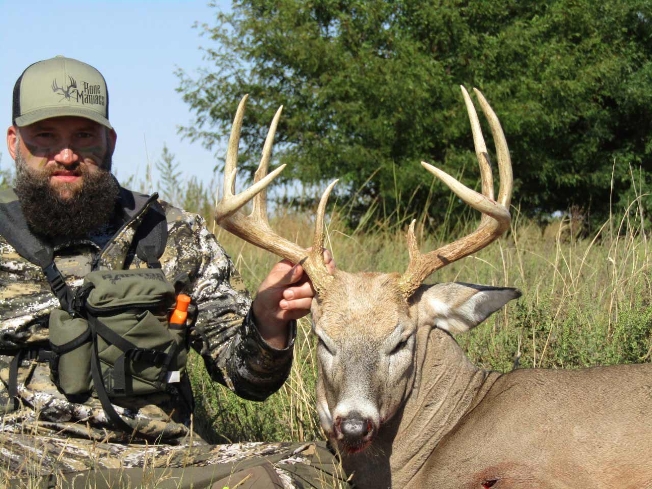 hunter with a whitetail buck