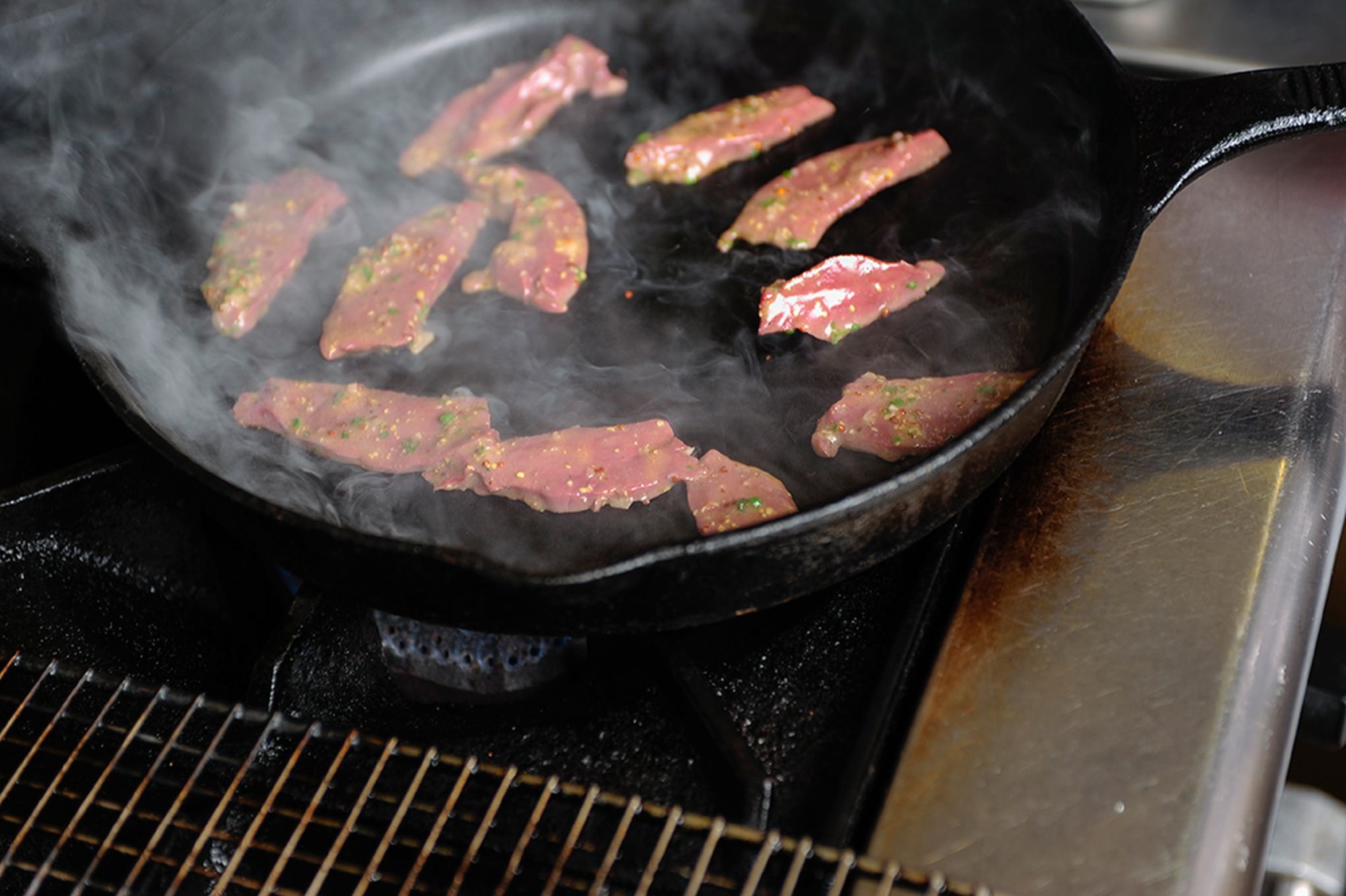 Charring venison heart.