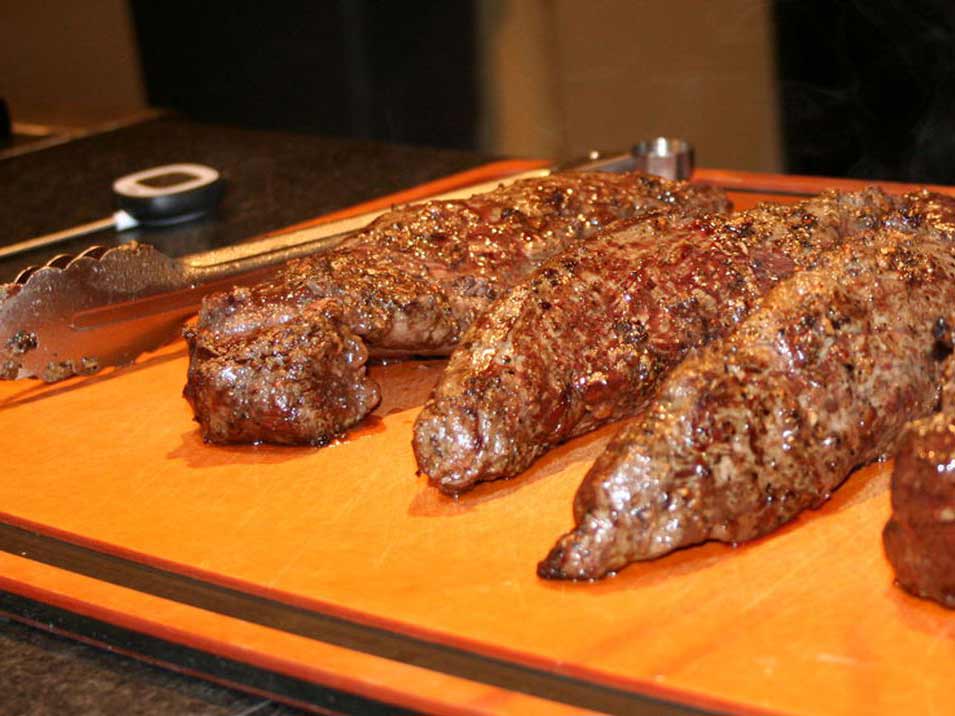 venison backstrap on a cutting board.