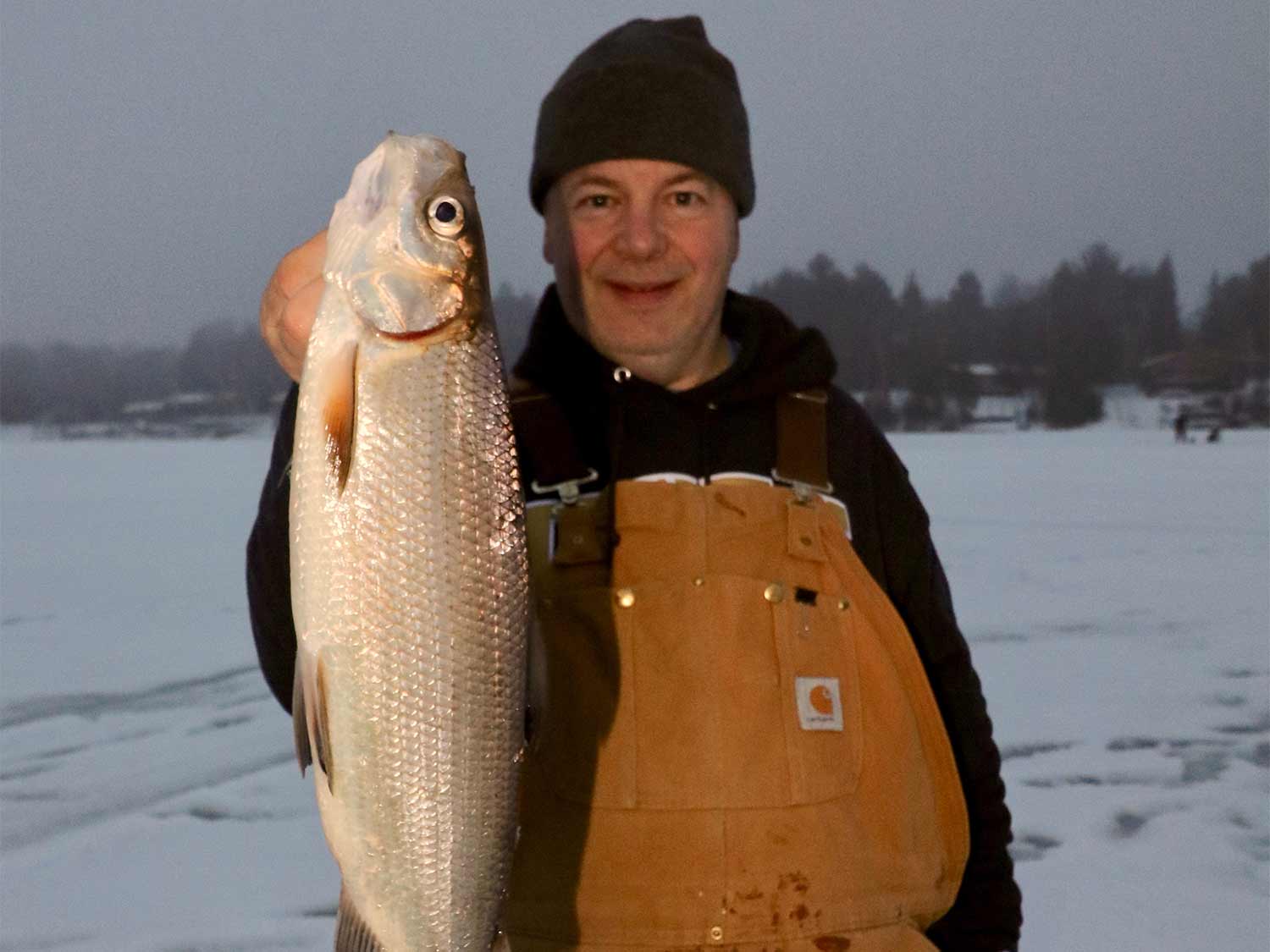 Angler holding up whitefish.