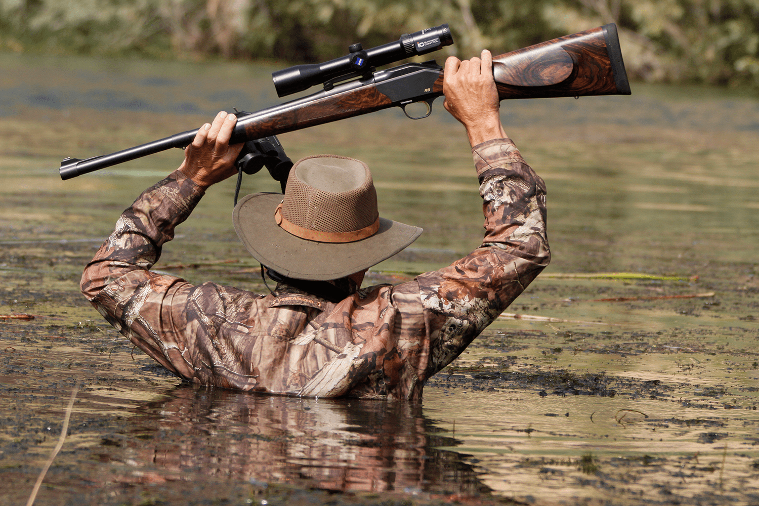 hunter wading through African waters.