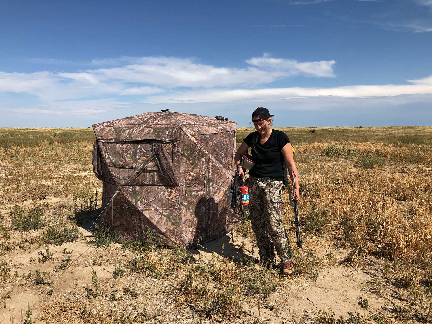 A hunter standing in a field.