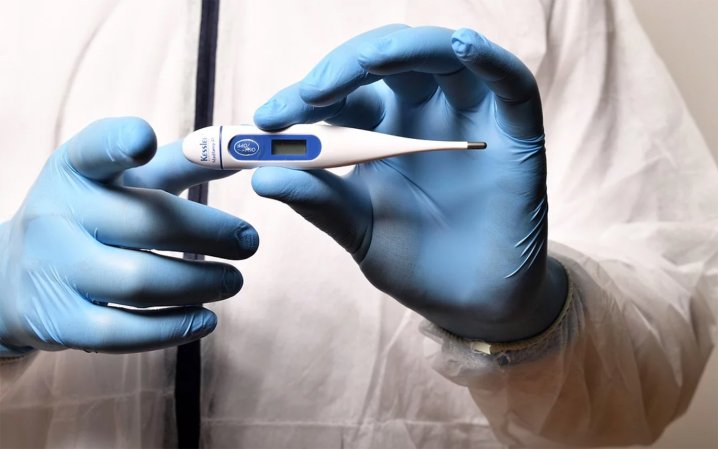 Lab assistant holding a thermometer.