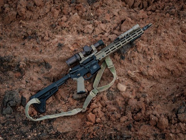 An AR rifle on the ground.