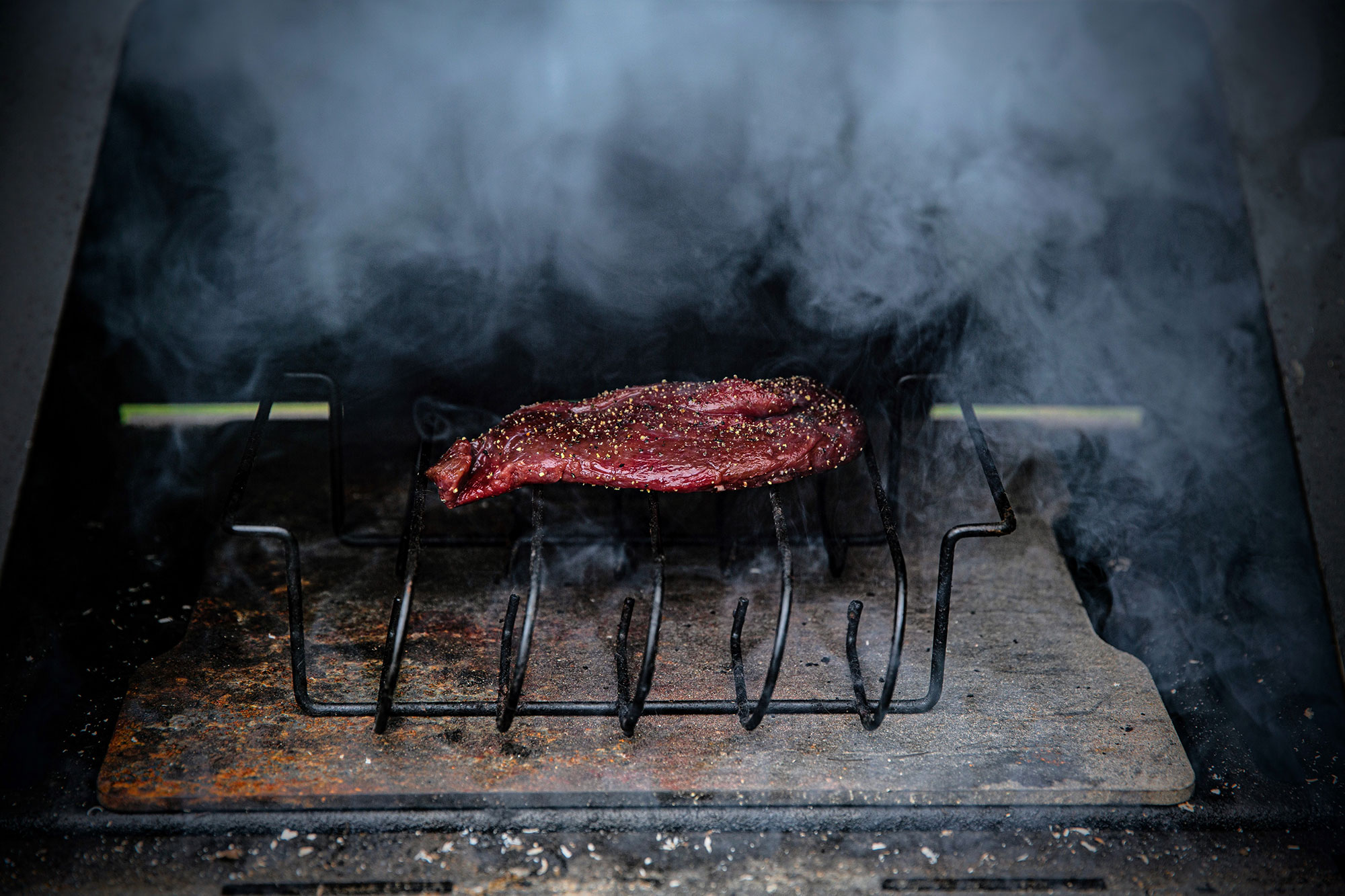 Smoke wild game steaks at low temperatures for longer to impart more smoke flavor.