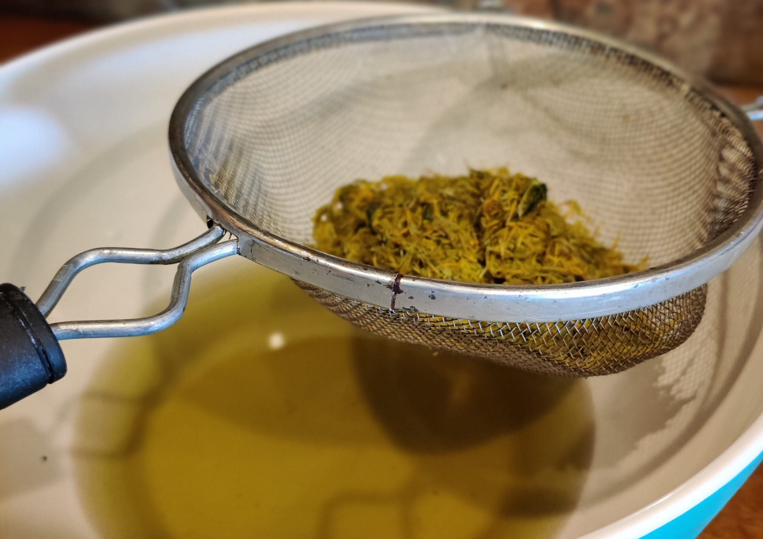 After boiling your dandelions you will need to strain them.