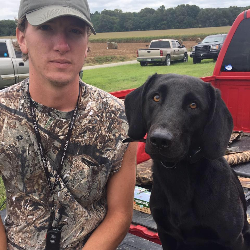 Grooms with his duck dog Avery.