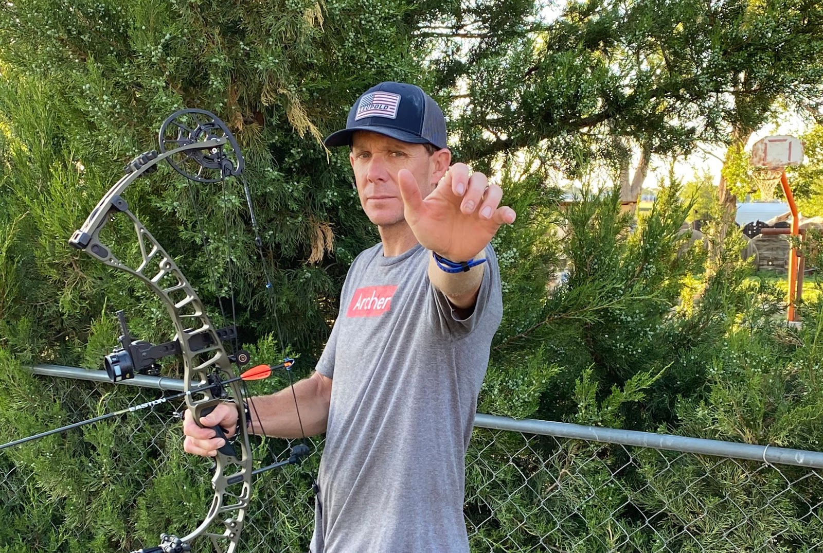 Man showing how to draw a compound bow with the right grip