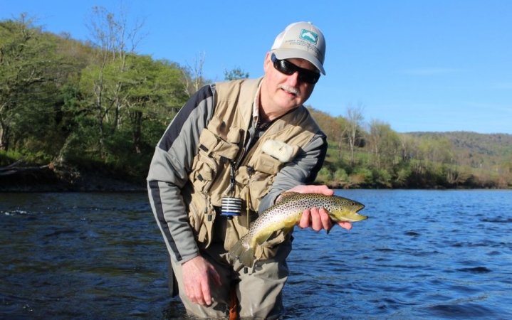 Man catching fish on a fly fishing rod and reel combo