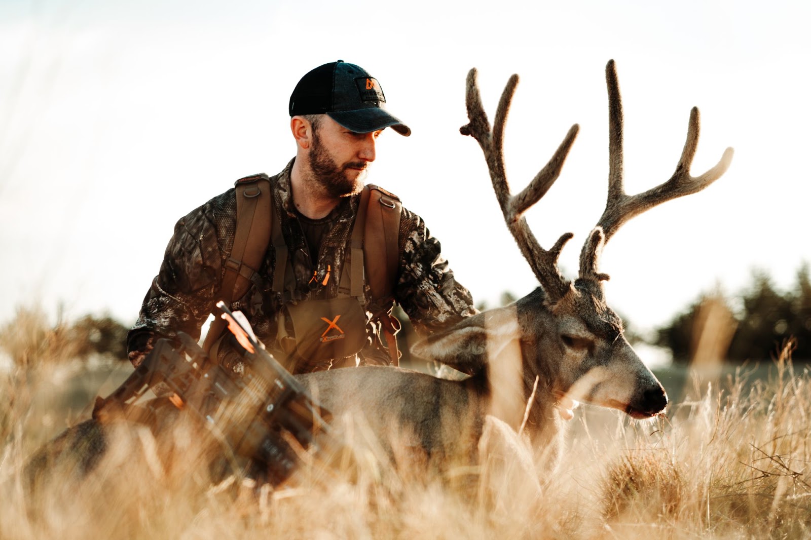 Hunter holding up mule deer shot with Mission Sub-1 crossbow