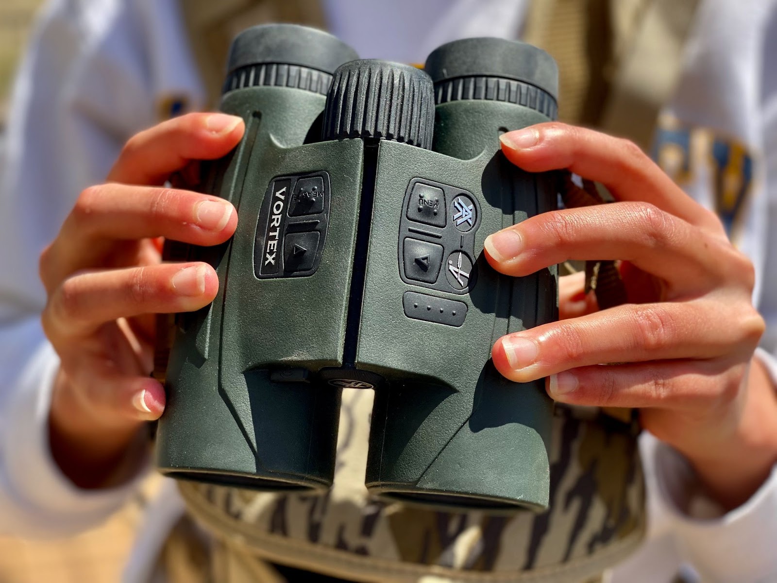 Holding the Vortex Fury HD 5000 AB rangefinding binoculars at the ready.