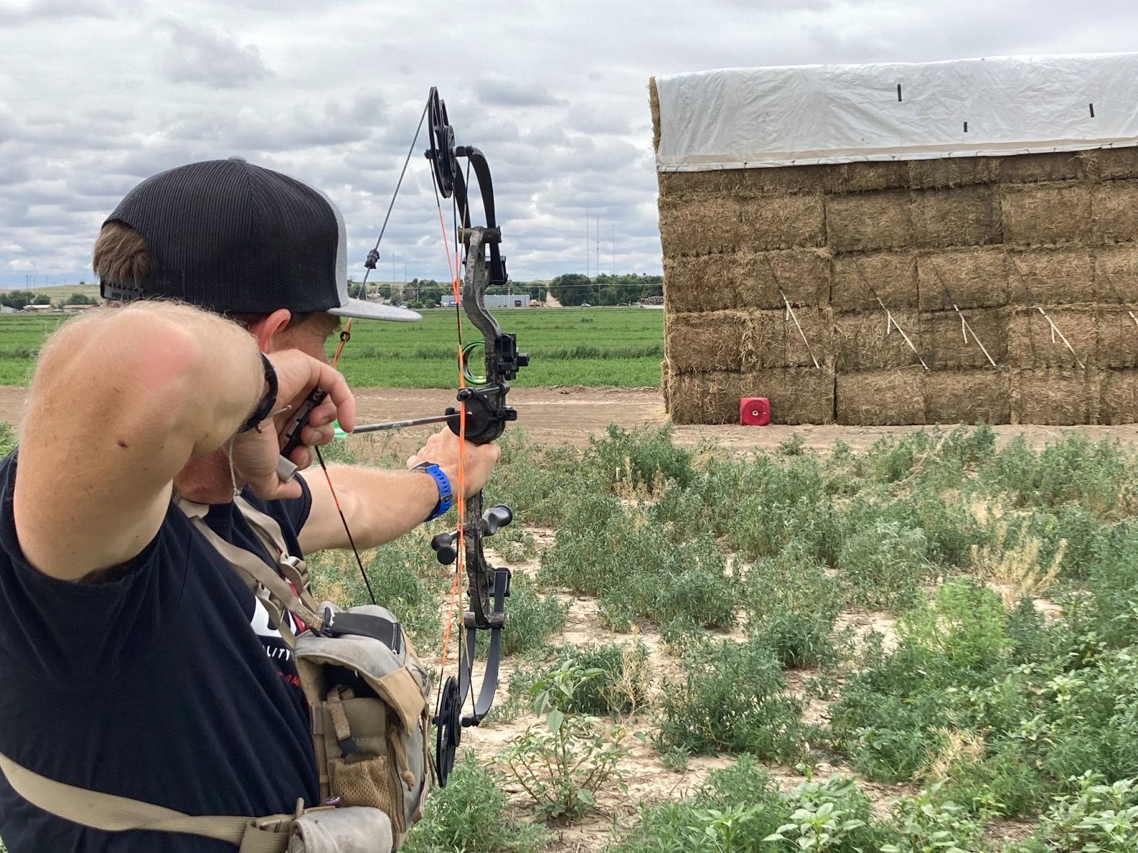 Man shooting compound bow