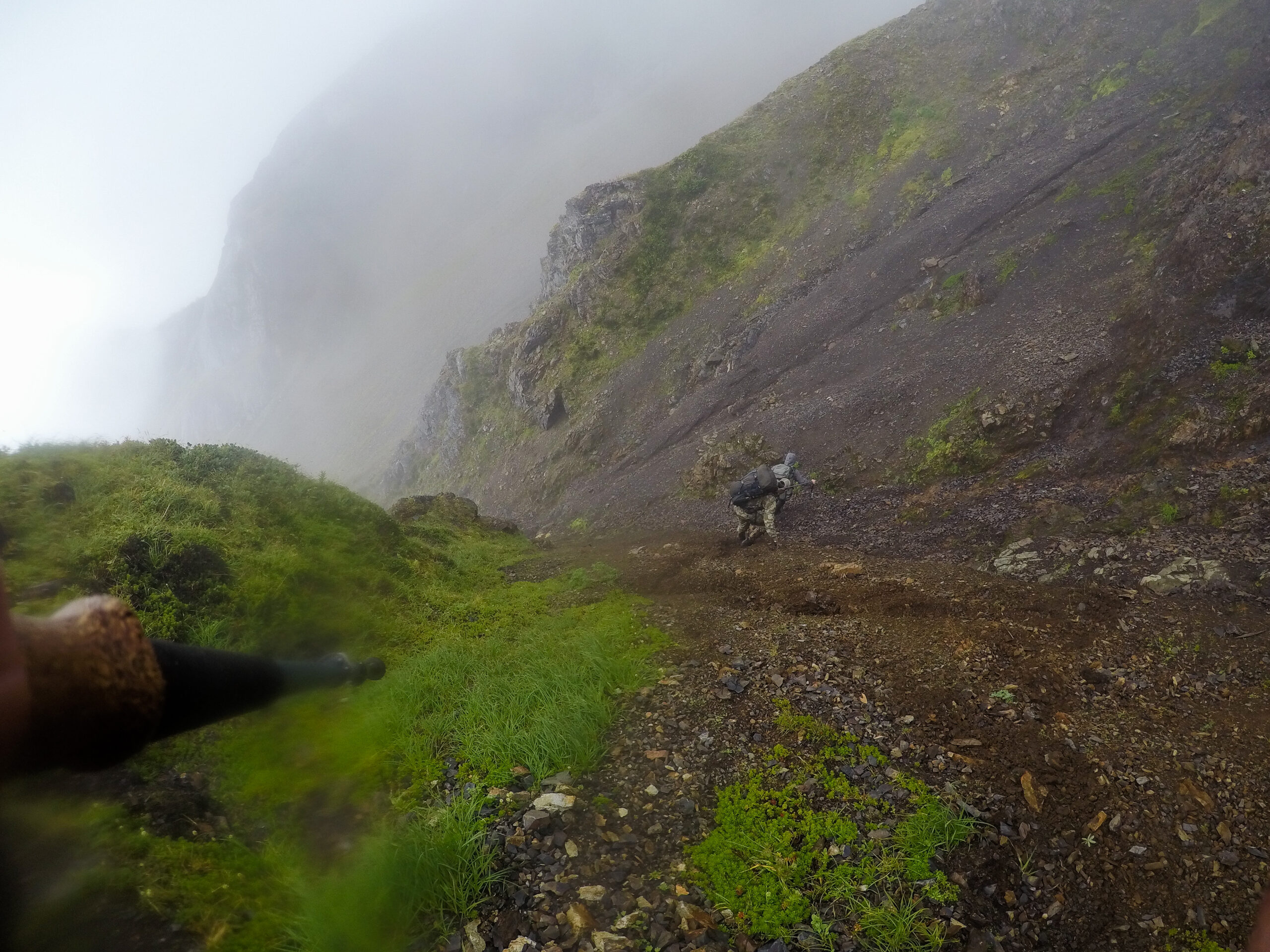 Hunters climbing down a mountain in Alaska.