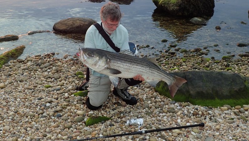 The author poses with a fish he caught.