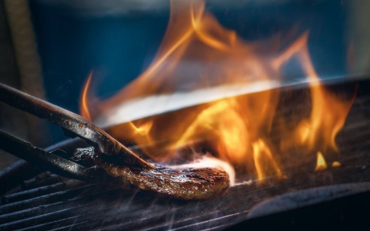 A burger on a portable grill.