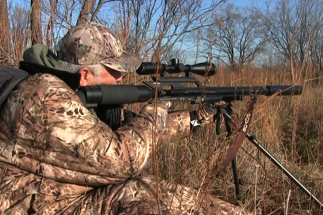 A man in camouflage aiming the AirForce Texan air rifle on a hunt