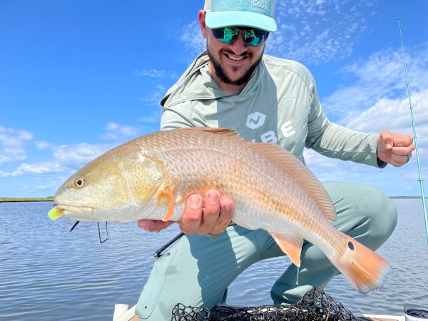 A man holding a redfish