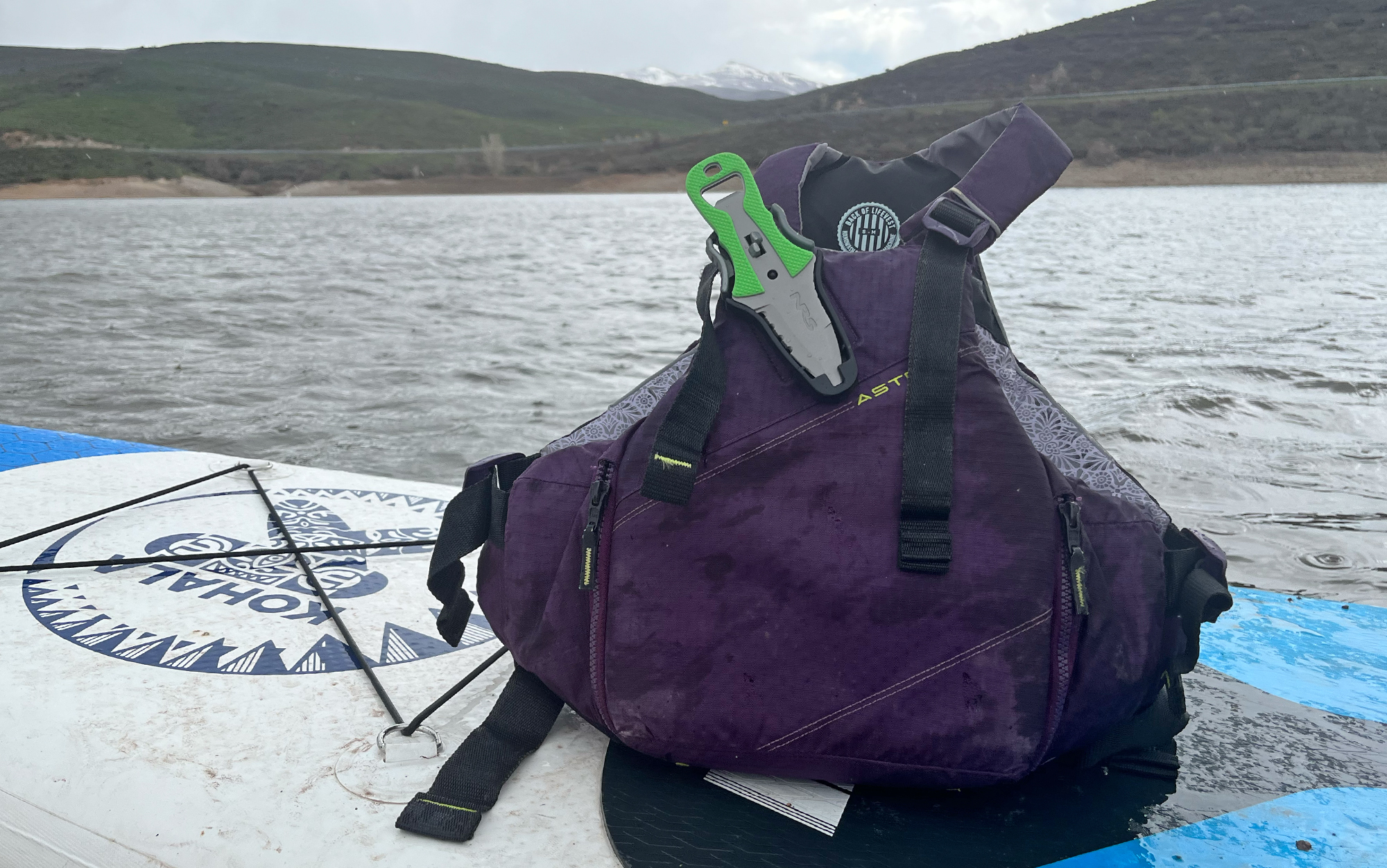 The Astral YTV sits on a paddle board.