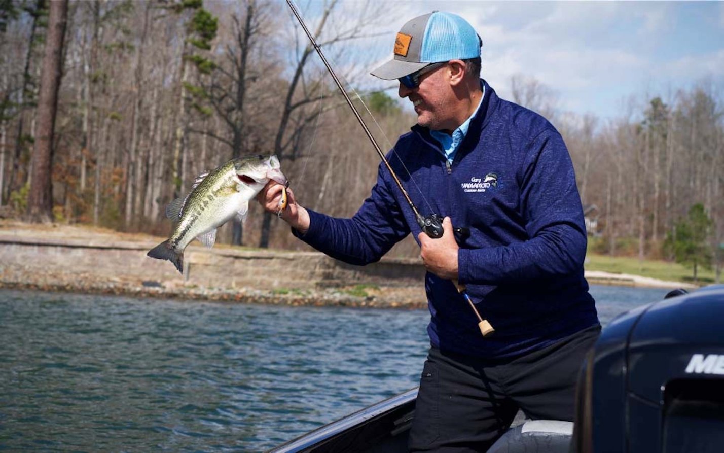 A man holding a fish on a boat