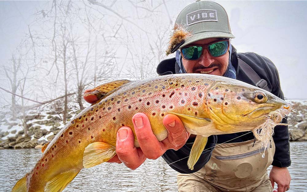 A man holding a yellow fish