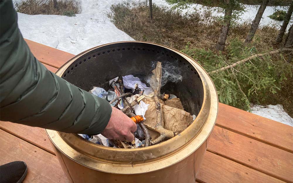 The author testing how lighters performed while starting a camp fire.