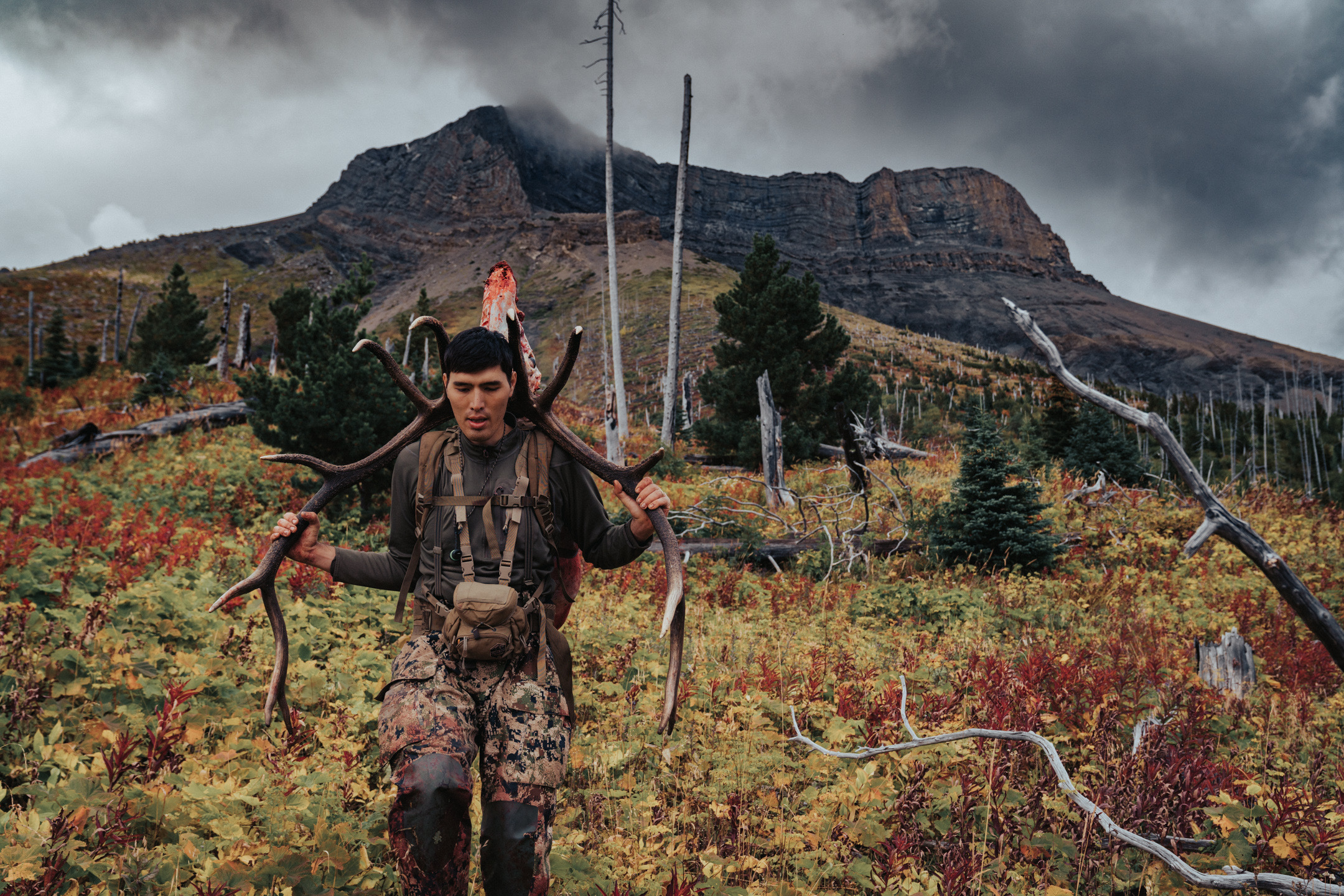 Hunter carrying elk antlers