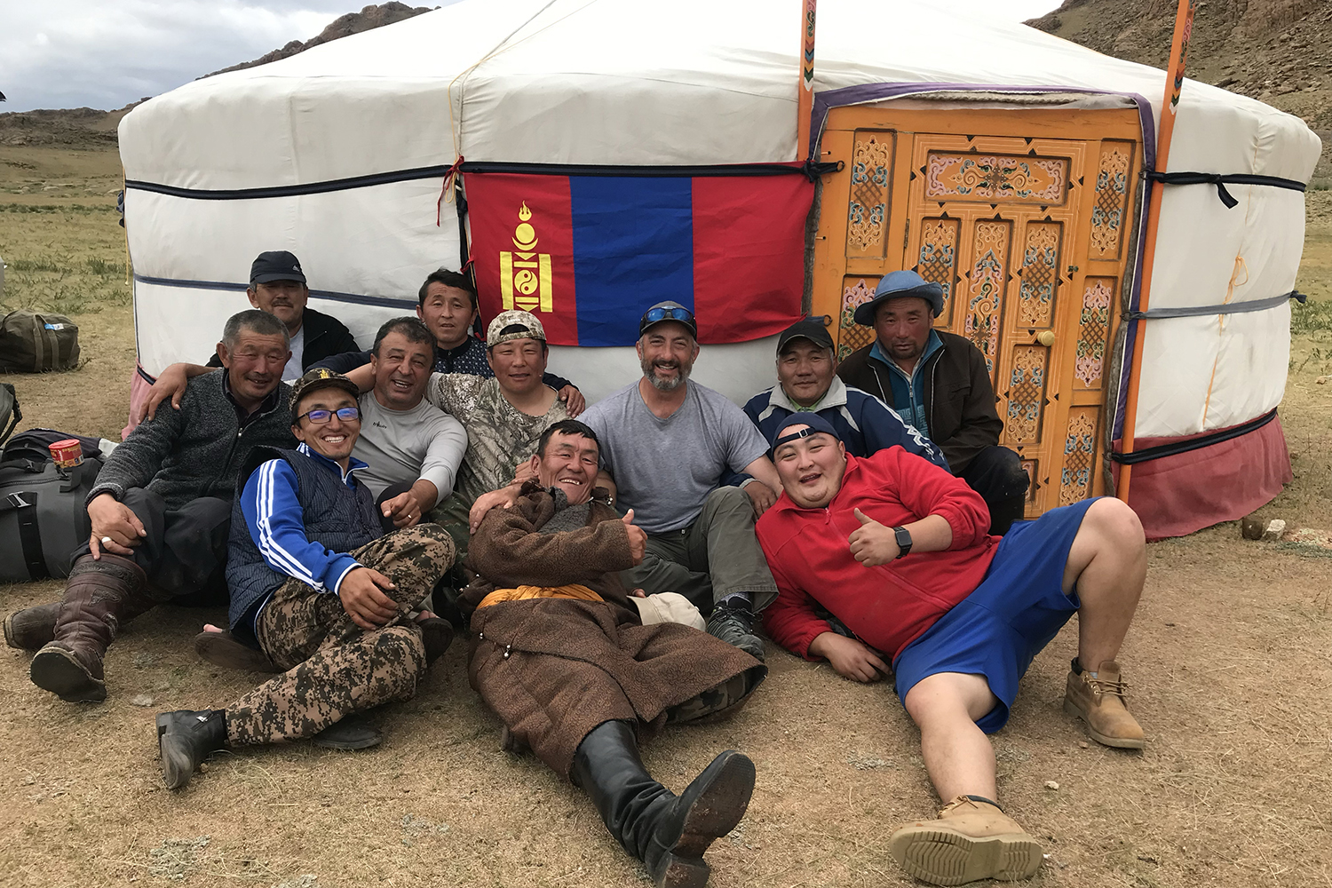 sheep hunters in camp in front of ger