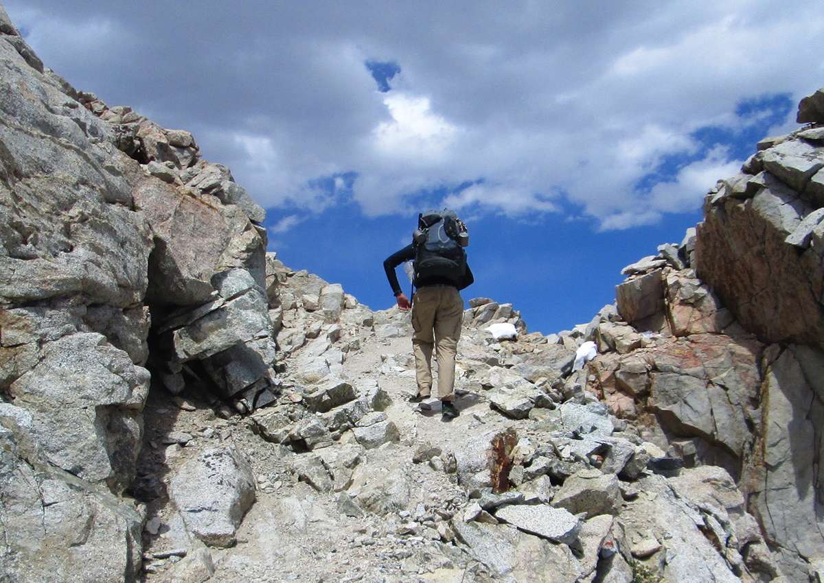 Hiker wears a base layer through a pass.