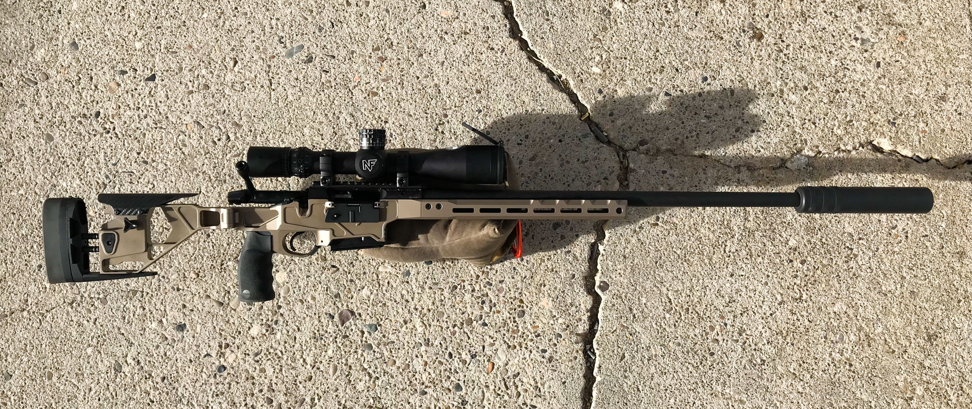 Long-range precision rifle on ground.