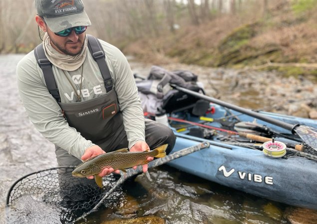 Hughs wears G3 waders and holds fish.