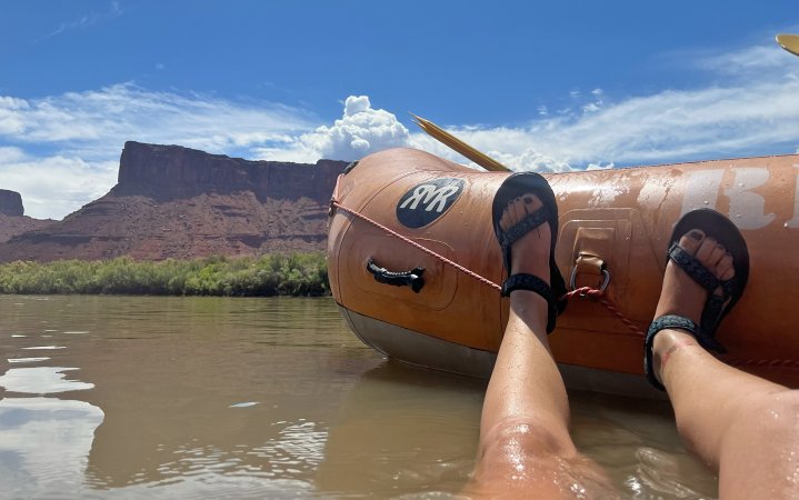 Woman wears Tevas in a river.