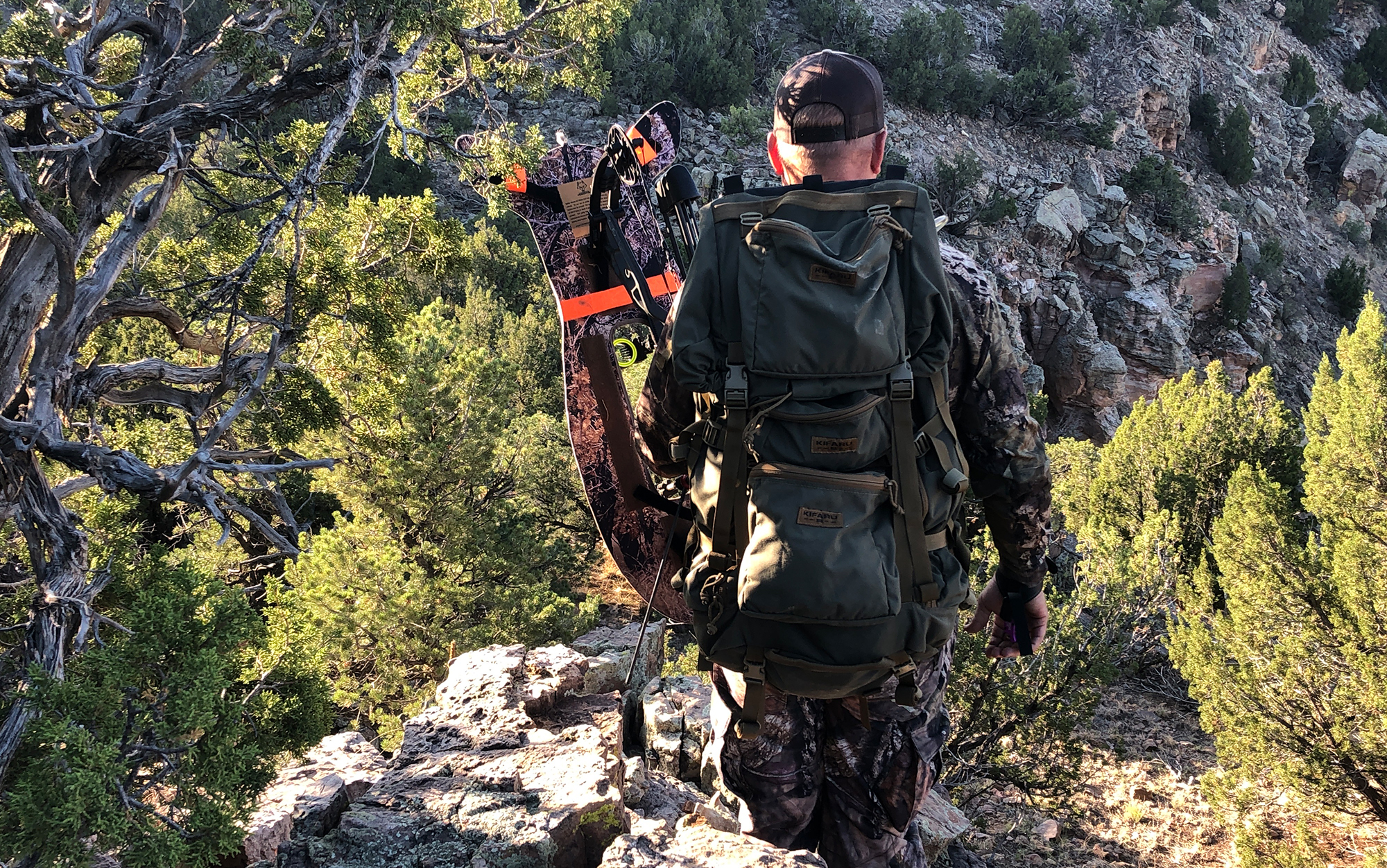 Hunter walks with elk decoy on bow.