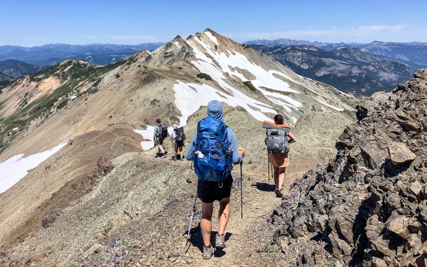 Four backpackers descend Old Snowy.