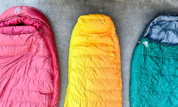 Down vs synthetic sleeping bags on a concrete background