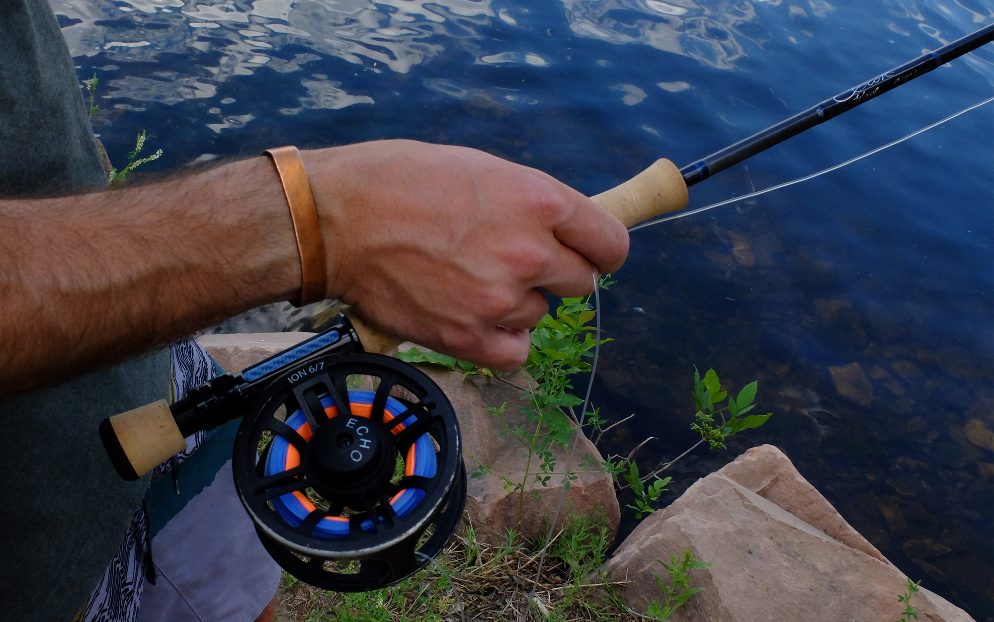 Angler holding the Scott Wave.