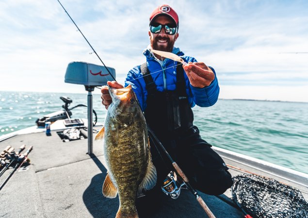 Angler poses with bass and jerkbait.