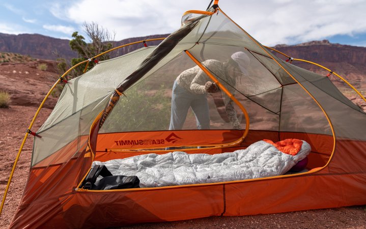 The Sea to Summit sits in a tent.